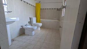 a bathroom with a toilet and a sink at Villa 19 Zone 2 Millennium City - Jaela in Ja-Ela +8 photos