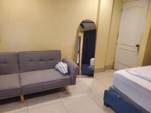 a living room with a couch and a mirror at Casona Blanca Guesthouse in Chinandega