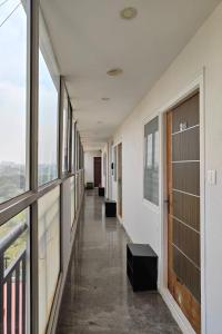 an empty hallway in a building with windows at Visaara Luxury Homes in Kammasandra