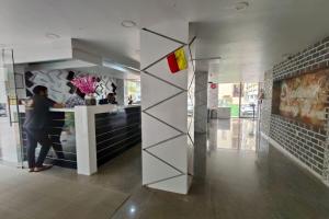 a woman standing at a counter in a building at Visaara Luxury Homes in Kammasandra