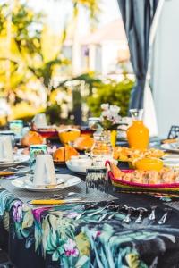 a table with plates of food on top at Le Palmier de la Paix in Le Tampon