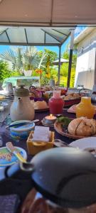 a table with plates of food on it at Le Palmier de la Paix in Le Tampon +36 photos