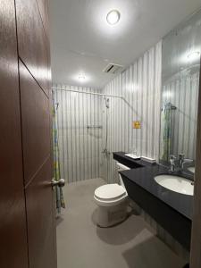 a bathroom with a toilet and a sink at Bantay Viajeros Inn in San Julian Norte +33 photos