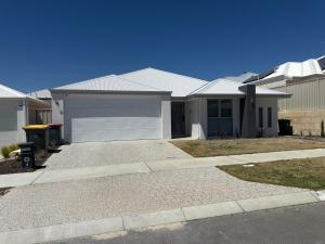 a house with a white garage at Beach House Shared in Alkimos