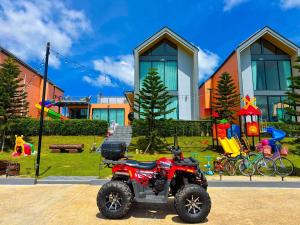 a red atv parked in front of a playground at MK Land Pool Villa Khaokho in Khao Kho +62 photos