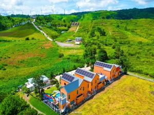 an orange house with solar panels on a hill at MK Land Pool Villa Khaokho in Khao Kho
