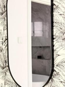 a bathroom with a mirror on a wall at Tranquil Ridge BnB in Blantyre +71 photos