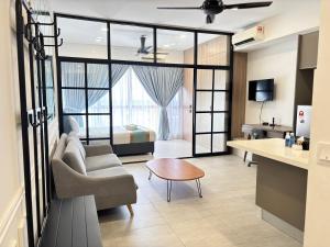 a hotel room with a bed and a living room at Bell Suites by Salaam Suites in Sepang