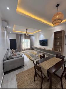 a living room with a table and a couch at Tranquil Ridge BnB in Blantyre