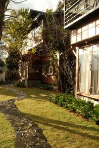 a building with a stone walkway in front of it at SIA Home - Dalat Haus in Ấp Ða Lợi