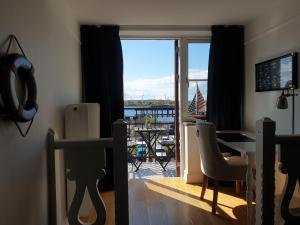 a living room with a view of a balcony at Hamnhotellet Kronan in Landskrona