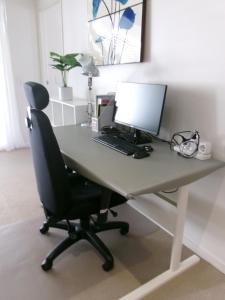 a desk with a computer on top of it at Merivale stay in South Brisbane two beds two baths one parking in Brisbane +24 photos