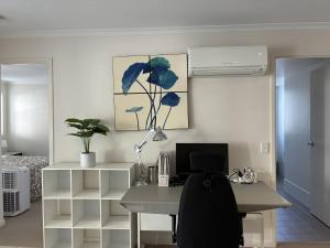 an office with a desk with a computer on it at Merivale stay in South Brisbane two beds two baths one parking in Brisbane