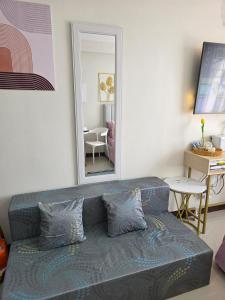 a living room with a couch and a mirror at Saekyung Lapu-lapu in Suba