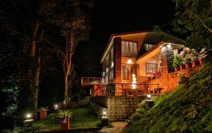 a house on a hill at night at VOX Vanam Bungalow in Kodaikānāl