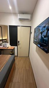 a room with a large flat screen tv on a wall at Grand Valora Puspowarno Kostel in Kalibanteng-lor
