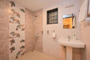 a bathroom with a sink and a shower at Lifeline Villas - Horizon Backwater Luxe Infinity Pool Villa in Mahabaleshwar +26 photos
