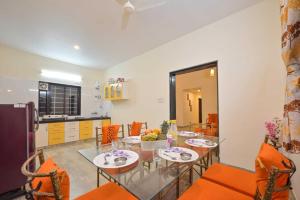 a kitchen and dining room with a table and chairs at Lifeline Villas - Horizon Backwater Luxe Infinity Pool Villa in Mahabaleshwar