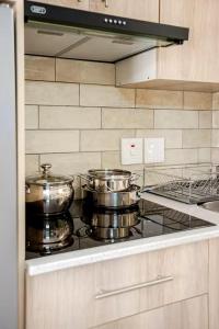 two pots and pans on a stove in a kitchen at Executive en-Suite - Southgate in Southgate +5 photos