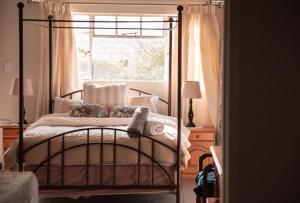 a bedroom with a bed and a window at Chilli cottage - off grid get away in Mkondeni