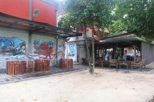a building with a mural on the side of it at Dermaga Resort Pramuka in Pulau Pramuka
