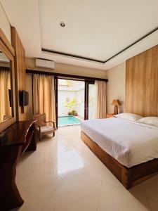 a bedroom with a bed and a desk and a television at Villa Reisya in Nusa Dua +25 photos