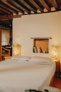 a bedroom with a white bed and a window at Patan Hideaway in Pātan
