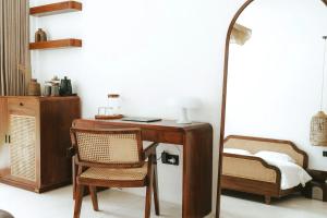 an office with a desk and a chair and a mirror at Tyde Bali Boutique Hotel in Uluwatu