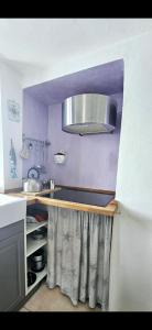 a kitchen with a sink and a silver hood at Agave di mare in Riomaggiore +6 photos