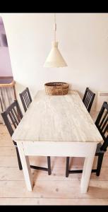 a white table with chairs and a basket on top at Agave di mare in Riomaggiore