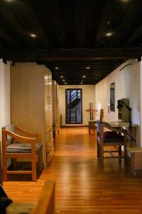 a large room with wooden floors and wooden chairs at Patan Hideaway in Pātan
