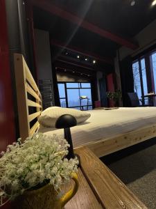 a bedroom with a large bed and a table with flowers at Baraka Suite in İznik