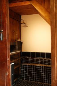 a bathroom with a black and white tiled wall at SIA Home - Dalat Haus in Ấp Ða Lợi +61 photos