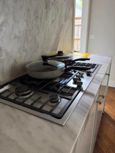 a kitchen stove with a pan on top of it at Deva house in Box Hill