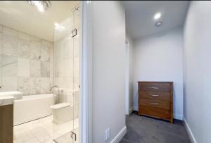 a bathroom with a tub and a sink and a shower at Deva house in Box Hill +30 photos