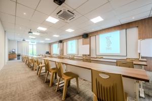 a large room with a long table and chairs at O&G Hotel Parit Buntar in Parit Buntar