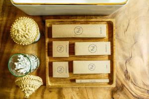 a wooden tray with three boxes on a table at Kama Haven in Semaya