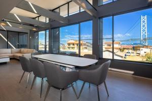 a dining room with a table and chairs and a bridge at Ocean Bridge - Vacation STAY 76453v in Awaji