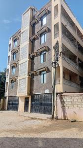 a tall building with windows on the side of it at Breezes home Bamburi in Bamburi