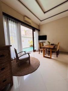 a living room with a table and a dining room at Villa Reisya in Nusa Dua