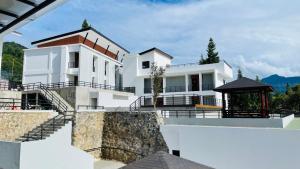 a white house with stairs and a gazebo at Alfa Jivana Resort in Sampal 2