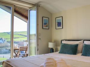 a bedroom with a bed and a sliding glass door at 10 Oceans Edge in Kingsbridge +27 photos