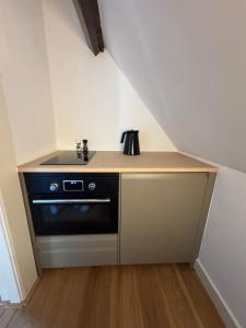 a kitchen with a stove and a counter top at Big loft 100m from beach in Scheveningen