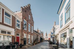 an empty street in a city with buildings at Big loft 100m from beach in Scheveningen