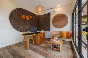 an office with a desk and a chair and a table at Cove Chara in Jimbaran