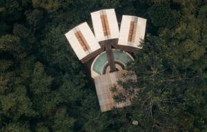 an overhead view of a statue in the middle of a forest at Nirata Treehouse in Kintamani