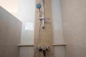 a shower in a bathroom with a shower head at Chateau de Sukhumvit in Bangkok +62 photos