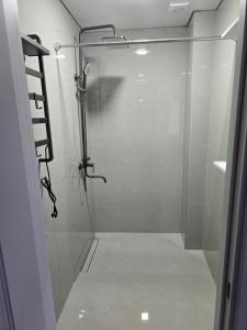 a bathroom with a shower with a glass door at В Центре Экибастуза in Ekibastuz