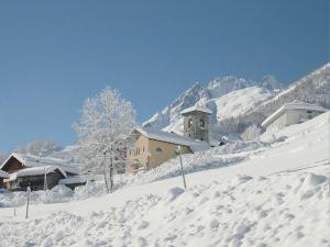 a snow covered mountain with a building in the background at Splendid ski-in,ski-out historical chalet! in La Lechere