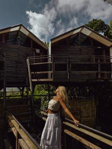 a woman in a dress standing in front of a building at Nirata Treehouse in Kintamani